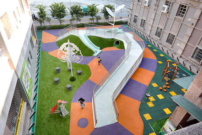 高雄市第一座校园「共融式无障碍游乐场」，以校园「百年老榕树」结合卡通动画「爱丽丝梦游仙境」为设计规划主题，创造出色彩缤纷又富想像的游戏场域。(摄影/Carter)