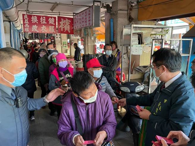 市長黃偉哲（右一）29日到白河市場發抵用券，吸引大批民眾排隊領取。（台南市政府提供／張毓翎台南傳真）