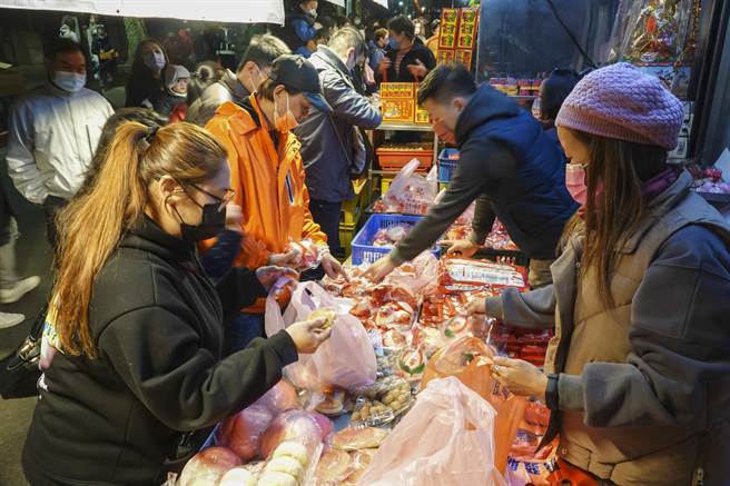 农历正月初九天公生，台北市松山奉天宫涌入许多信徒拜天公，庙口卖糕饼店家生意兴隆。（黄子明摄）