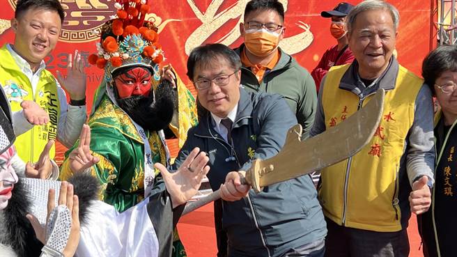 台南市长黄伟哲（左三）到盐水武庙宣传本周末的「盐水蜂炮」，他与扮成关圣帝君的磐果舞团小舞者一起耍大刀。（张毓翎摄）