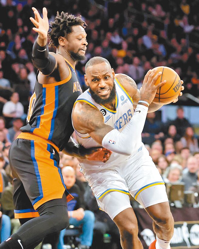 「小皇帝」詹姆斯（右）上演本季首次大三元，率领湖人经延长赛击败尼克。（路透）