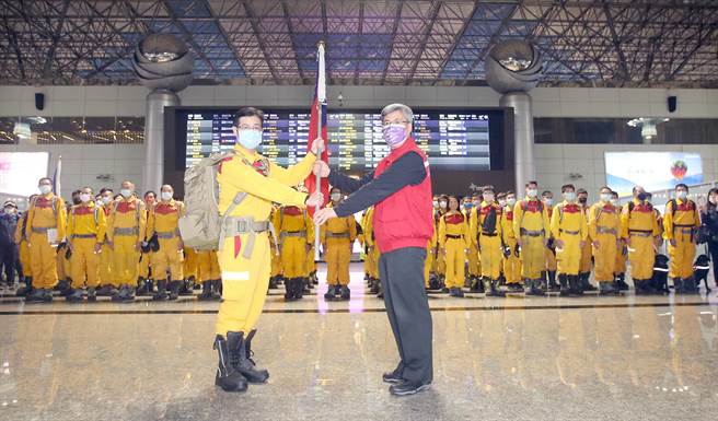 登機前行政院長陳建仁（右）授旗給搜救隊代表。（范揚光攝）