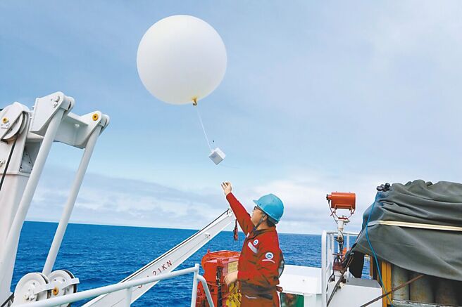 图为中国海洋科考人员在大西洋上空施放气球。（新华社）