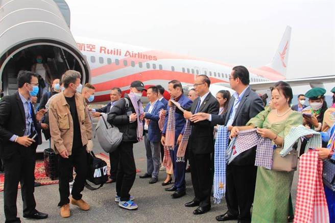 圖為柬埔寨官員在機場歡迎中國遊客。（摘自新華社）