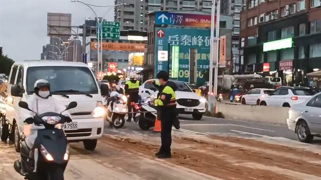 新北市淡水区民权路与民权一街路口，在今(20)日下午5时许遭经过的砂石车泄漏废土，造成车道上堆积大片的淤泥，使4名机车骑士滑倒受伤。(黄敬文翻摄)