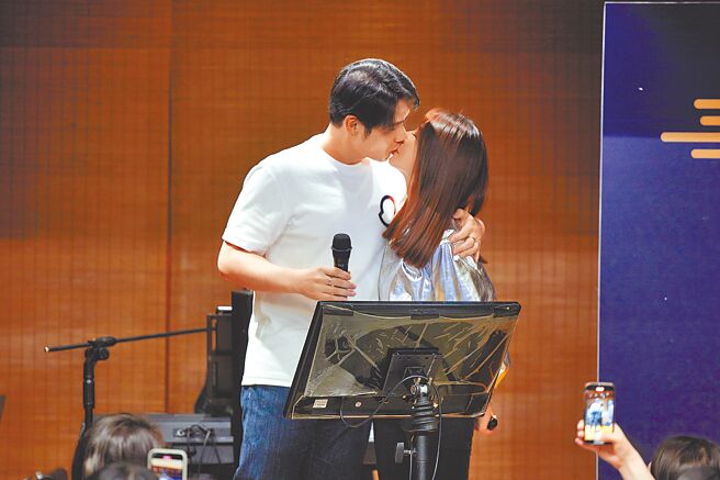 陈怡蓉（右）与老公薛博仁在春酒上被拱亲亲。（圣缇雅提供）