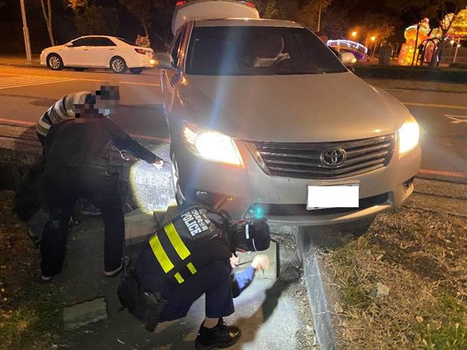 55岁陈姓男子日前晚间驾驶小客车行驶于雾峰区成功路段，因天色昏暗未注意路边高低差，导致车辆右前轮卡住悬空，无法脱困。（雾峰警分局提供／潘虹恩台中传真）