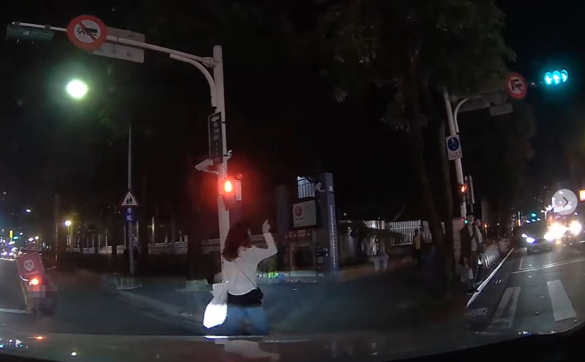 女驾驶在一处路口遭到行人挥手、狂指绿灯示意礼让，她停车礼让后傻眼嘆「妳的是红灯」。（翻摄自脸书社团我是东湖人社团版）