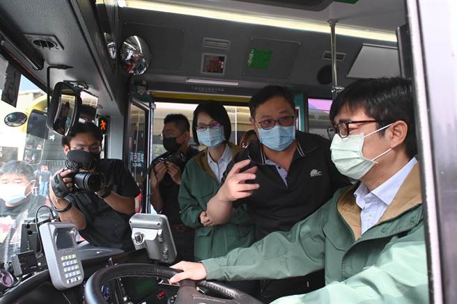 高雄市长陈其迈（右）13日出席模范公车表扬典礼，他坐上驾驶座，体验大车的驾驶情形。（林瑞益摄）