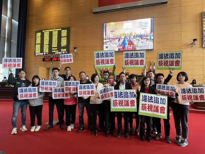 台中市议会民进党团反对市府追加购物节3.5亿元经费，举牌要求退回。(林欣仪摄)