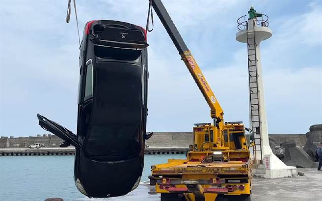 金樽渔港今天中午发生轿车坠海意外，轿车由吊车拉起。（翻摄画面）