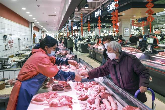 一位大陆民眾正在肉摊购买消费。（摘自中新社）