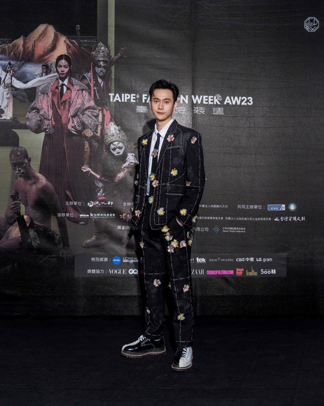 刘冠廷着周裕颖JUST IN XX 作品，西装上的缝线增加立体感，满满花朵与黑白鞋塑造俏皮感。（臺北时装周提供）