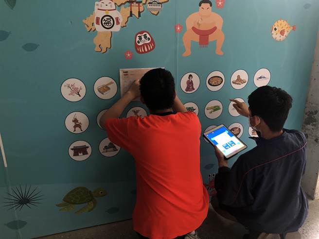 中山国中学生在美术课用平板AR扫描学习墙，认识各国文化。（张芷瑜摄）