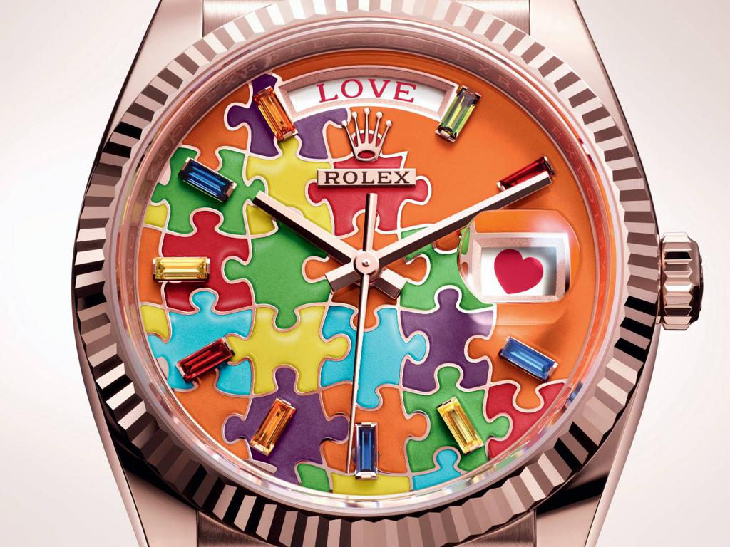 勞力士推出一款色彩繽紛的Day-Date 36腕表，日期窗和星期窗會出現可愛圖案與字句。(ROLEX提供)