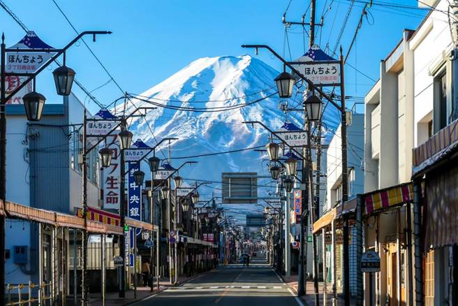 日本山梨县富士吉田市区商店街的一处十字路口可以远眺富士山。（图／达志影像）