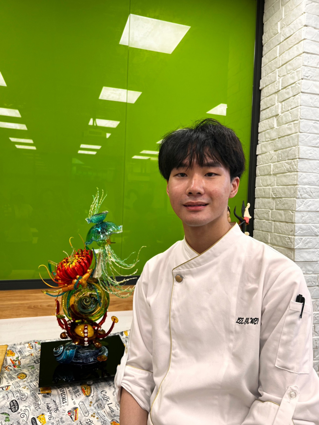 西点制作冠军得主李哲玮同学与参赛作品「海洋之心」合影。(照片/中臺科大提供)