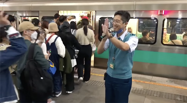 天团五月天昨在329成军日到高雄世运开唱，大批五迷疏散时挤爆高雄捷运站，其中1名高捷站长林忠明化身歌手，拿麦高歌舒缓旅客等待的疏运心情。（柯宗纬摄）