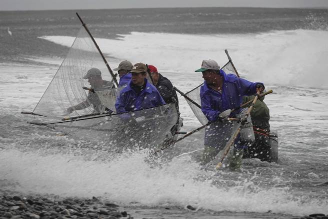 宜兰南澳神秘沙滩海边也有许多捕捉红头魩仔的民眾，他们通常习惯聚集在一起面对海岸方向作业。（黄子明摄）