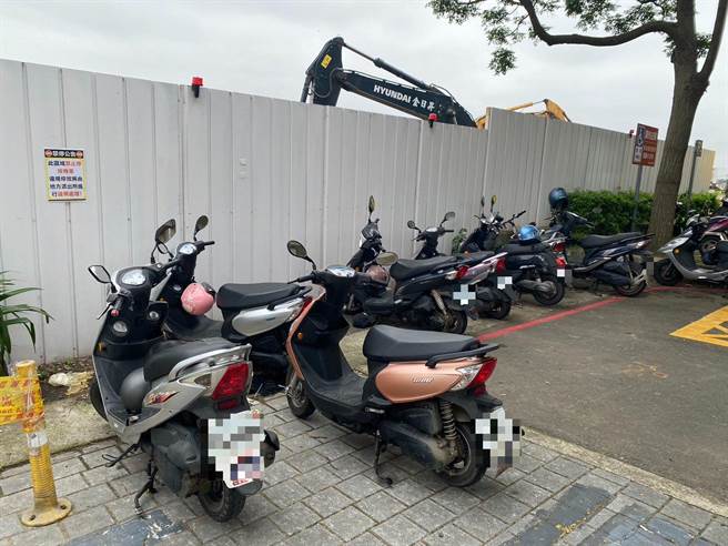 机捷A15大园站停车场出入口旁，围篱上张贴禁止停车公告，红线处仍停满整排机车。（蔡明亘摄）