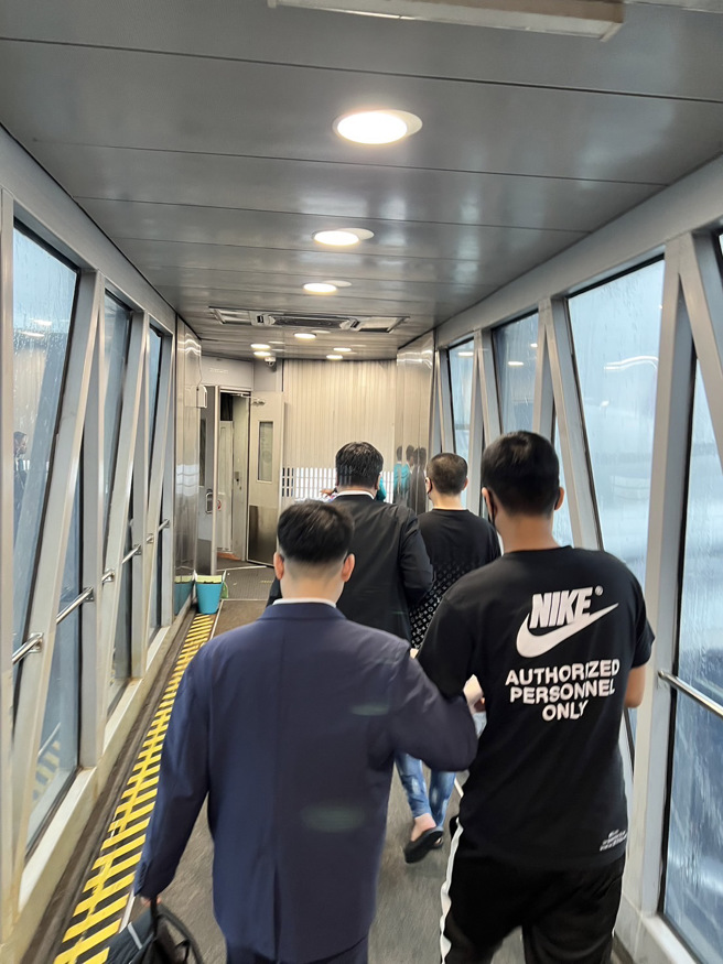 教唆掃射當鋪，弘仁會大哥「鯨魚」吉隆坡押解返台畫面曝光。(警方提供)