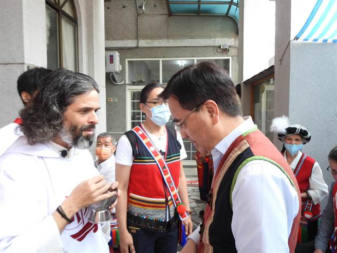 今天是天主教花莲教区德安堂区建教43周年，神父杜晋善（左）向原民会主委夷将·拔路儿（右）洒圣水祝福。（罗亦晽摄）