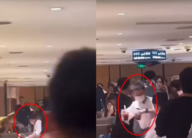 男子分享疑似在大陆海底捞店内，顾客斗殴影片，竟惊见员工赶紧收拾桌上的汤锅、饮料杯与餐具。（翻摄自脸书爆废公社）