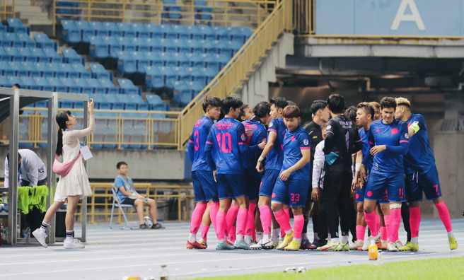 台湾石虎球员上场前，苗广雅（左）在一旁拍摄球员集合喊声。（台湾石虎提供）