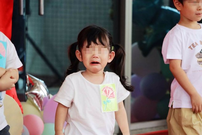 揭牌仪式上，小小孩有的放声大哭、有的显得不知所措，反应真实。（吕妍庭摄）