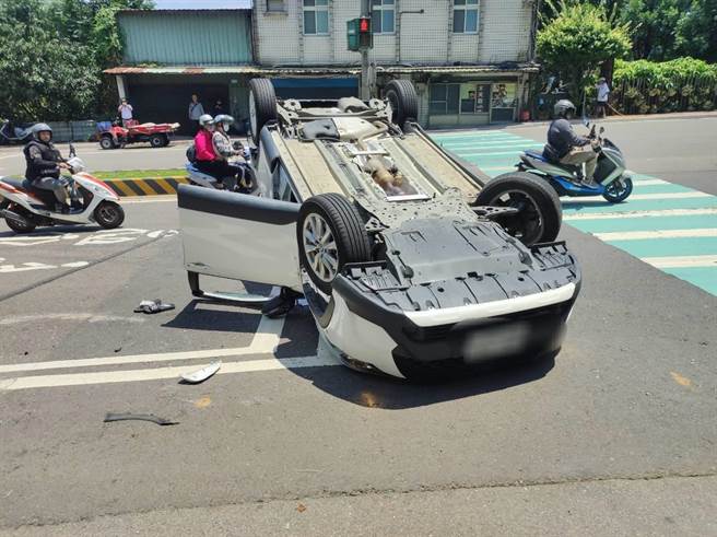 新北市八里今(10日)早上11時發生一起翻車意外，54歲鄭姓女子當時駕駛白色休旅車行駛在龍米路二段，行經米倉國小前因不明原因不慎擦撞路邊違停車輛，導致整輛車失控翻覆。(黃敬文翻攝)