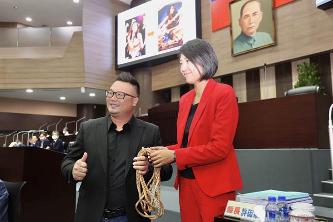 南投县议员简千翔赠县长许淑华神力女超人所使用的神器「金鞭」，盼她鞭策县府团队打造宜居城市。（杨静茹摄）