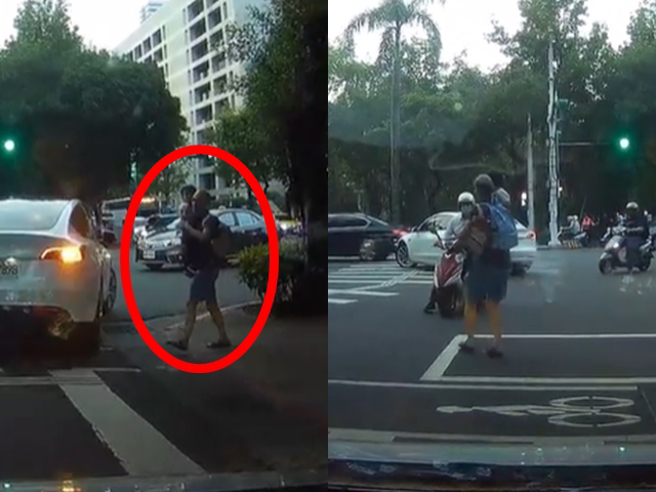 中年男子牵着幼童在巷口准备过马路，眼见号志是红灯，男子仍一把抱起幼童「闯红灯度衝过斑马线」，跑到一半时还差点被机车撞上。（翻摄自脸书「爆料公社」）