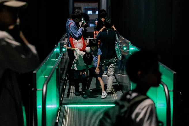 行走于《途中》的观眾可拿起手机扫描作品说明牌，或是散落在作品周遭地面的 QR Code，藉此开启活动专属的 Instagram 滤镜。（郭吉铨摄）