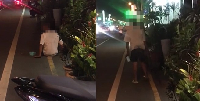 原本「用手走路」的白衣男子见四下无人，突然站起身，径自向前走去。（图／翻摄画面，刘姓网友授权）