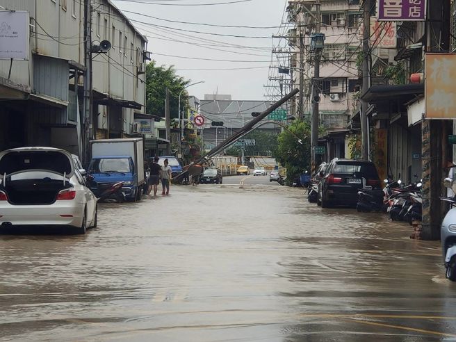 新北市新庄区琼林路今天上午11时许，发生电线杆倒塌意外，起因为该处地下水管破裂所导致，造成现场路面隆起、淹水。（翻摄自脸书爆料公社）