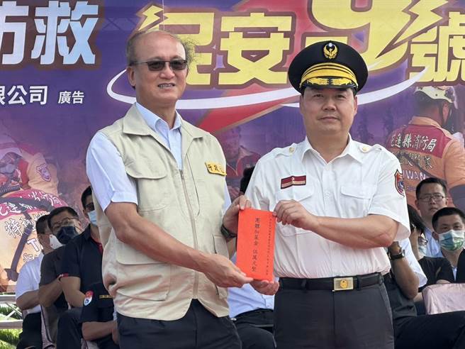 花莲县政府今在花莲港举行「全民防卫动员暨灾害防救（民安9号）演习」实作演练，演习指导官、教育部常务次长林腾蛟（左）肯定成果，颁发加菜金给消防局代理局长吴兆远（右）。（罗亦晽摄）
