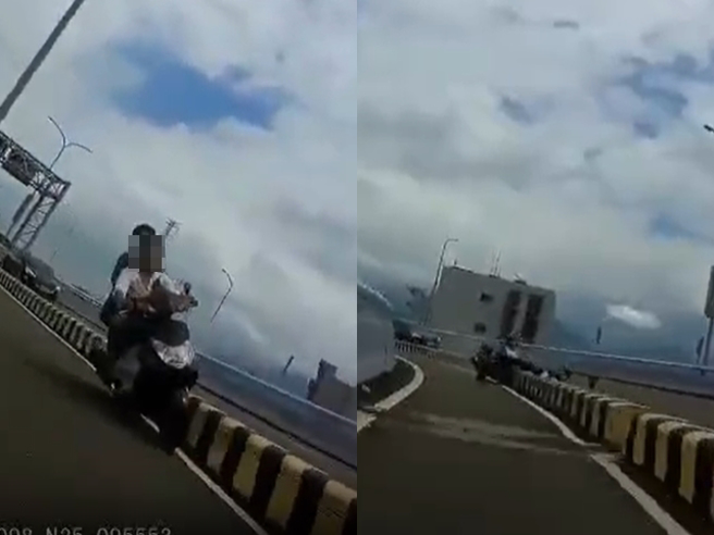 一辆双载机车被目击车上2人不但没戴安全帽，还在高架桥机车道上飙驶超车，最后在一处弯道竟擦撞护栏，2人当场摔飞到汽车道上。（翻摄自脸书「爆废公社二馆」）