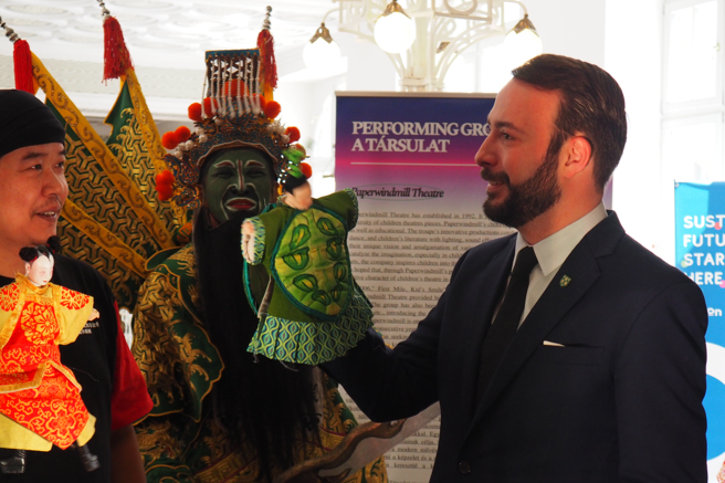 布達佩斯第2區副市長丹尼爾．伯格（Daniel Berg）跟著山宛然劇團武山老師體驗布袋戲操作，感受台灣的藝術文化。（文化總會提供）