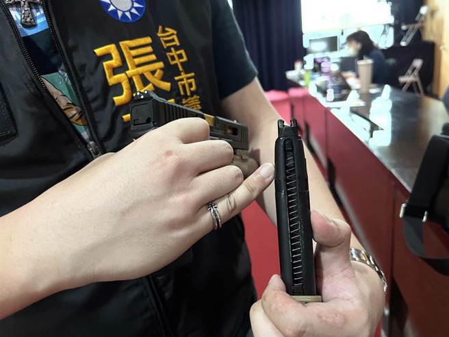 台中市議員張彥彤拿出生存遊戲用的玩具槍，強調是以瓦斯為動力，呼籲警方掃蕩槍枝不要搞錯方向。(林欣儀攝)