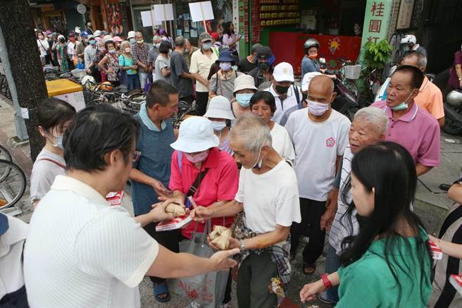 端午节前夕送爱心，「刈包吉」在龙山寺公园发便当与粽子，吸引民眾大排长龙。（王英豪摄）