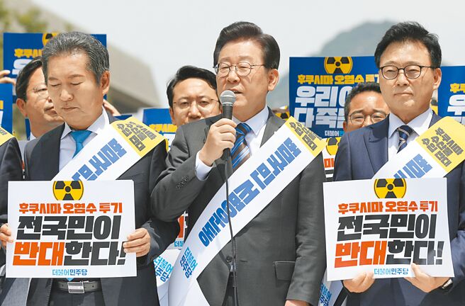 韩国共同民主党党魁李在明（中）19日就福岛核污水排放入海计画，批评日本政府「固执于简单廉价的方式」。图为韩国共同民主党5月26日在首尔反对核污水排海。（新华社）