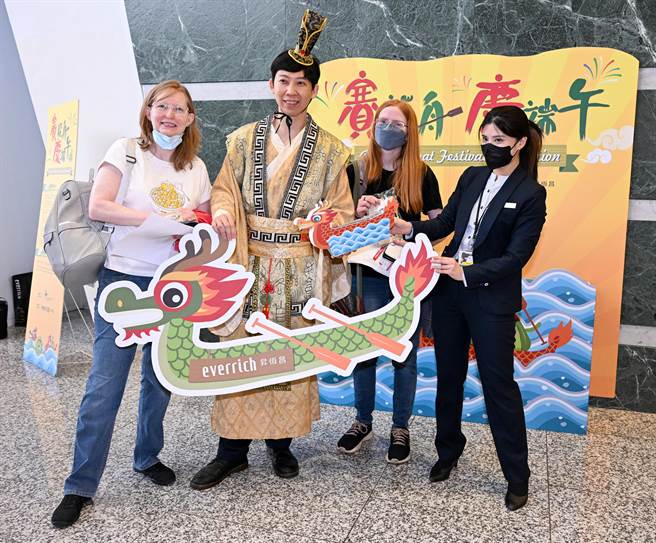 端午節連假即將展開，桃機昇恆昌免稅商店21日特別舉辦「賽龍舟、慶端午」活動，由工作人員打扮成屈原，向外國遊客講解端午節的由來，並體驗陸上賽龍舟活動，讓出國旅客感受端午節日氛圍。（陳麒全攝）