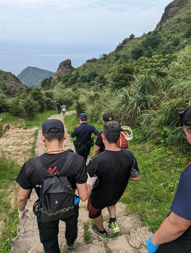 ▲警消护送受伤民眾古男谨慎下山就医。（新北市警局提供／徐佑升新北传真）