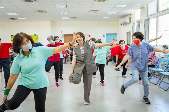 屏东县长周春米与沟美及仁爱社区据点长者同乐，表演热情活力的健康操。(屏县府提供)