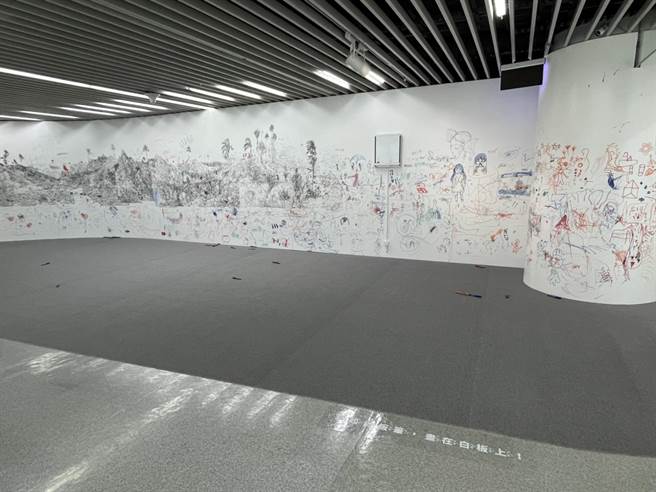 艺术家彭奕轩的作品《白板写生》，邀请民眾拿起展场中的画笔，大肆挥洒在白墙上。（陈梦茹摄）