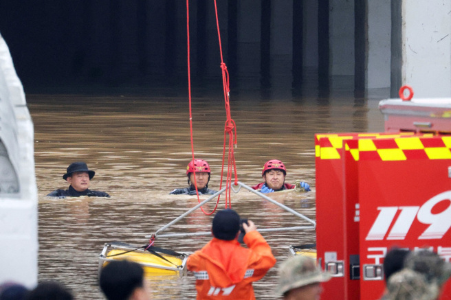 南韓暴雨導致河水潰堤，淹沒忠清北道五松一處地下道，一輛公車內發現5具遺體。（圖／路透社）