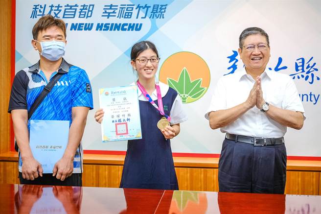 竹北高中学生徐语彤（中）在德国夏季世界特殊奥林匹克运动会夺5公里公路赛金牌，为竹县首面特奥金牌，县长杨文科（右）勉励再接再厉。（罗浚滨摄）