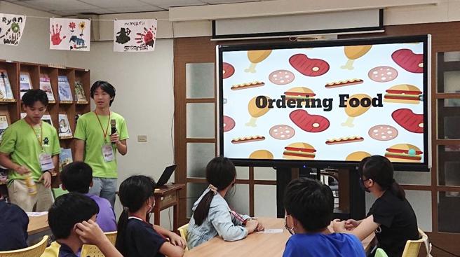 志工大哥哥们因为年纪相仿，除了教学外，还可以用英文跟学生聊彼此共同的兴趣，上课跟下课一样都很热闹。（图／高雄市教育局）