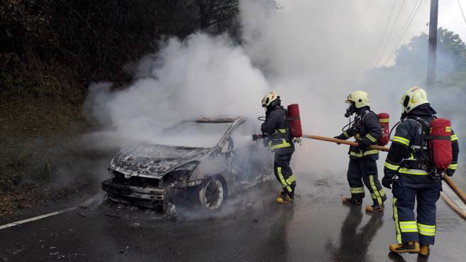 新北市1輛休旅車今（3）日12時許行經106縣道75.5公里處突然冒煙，將車停靠路邊後就起火燃燒。（新北市消防局提供／徐佑昇新北傳真）