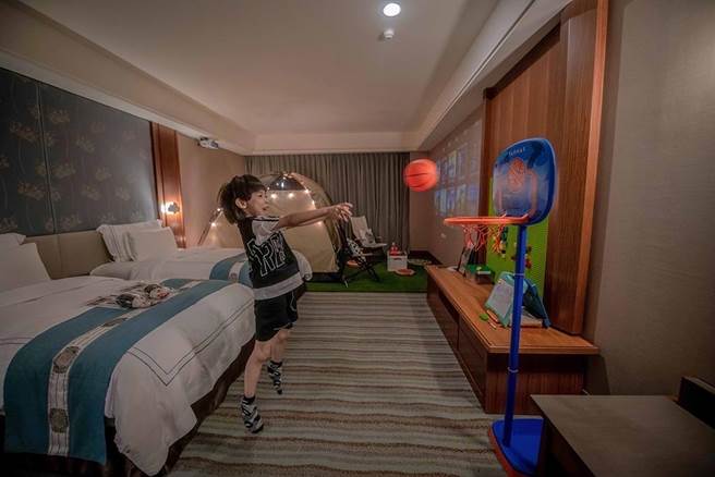 「露营主题房」在室内铺草皮、搭帐篷、网美挂灯、露营椅等，还有120吋投影电视，让客房一秒变戏院。（福容大饭店提供）